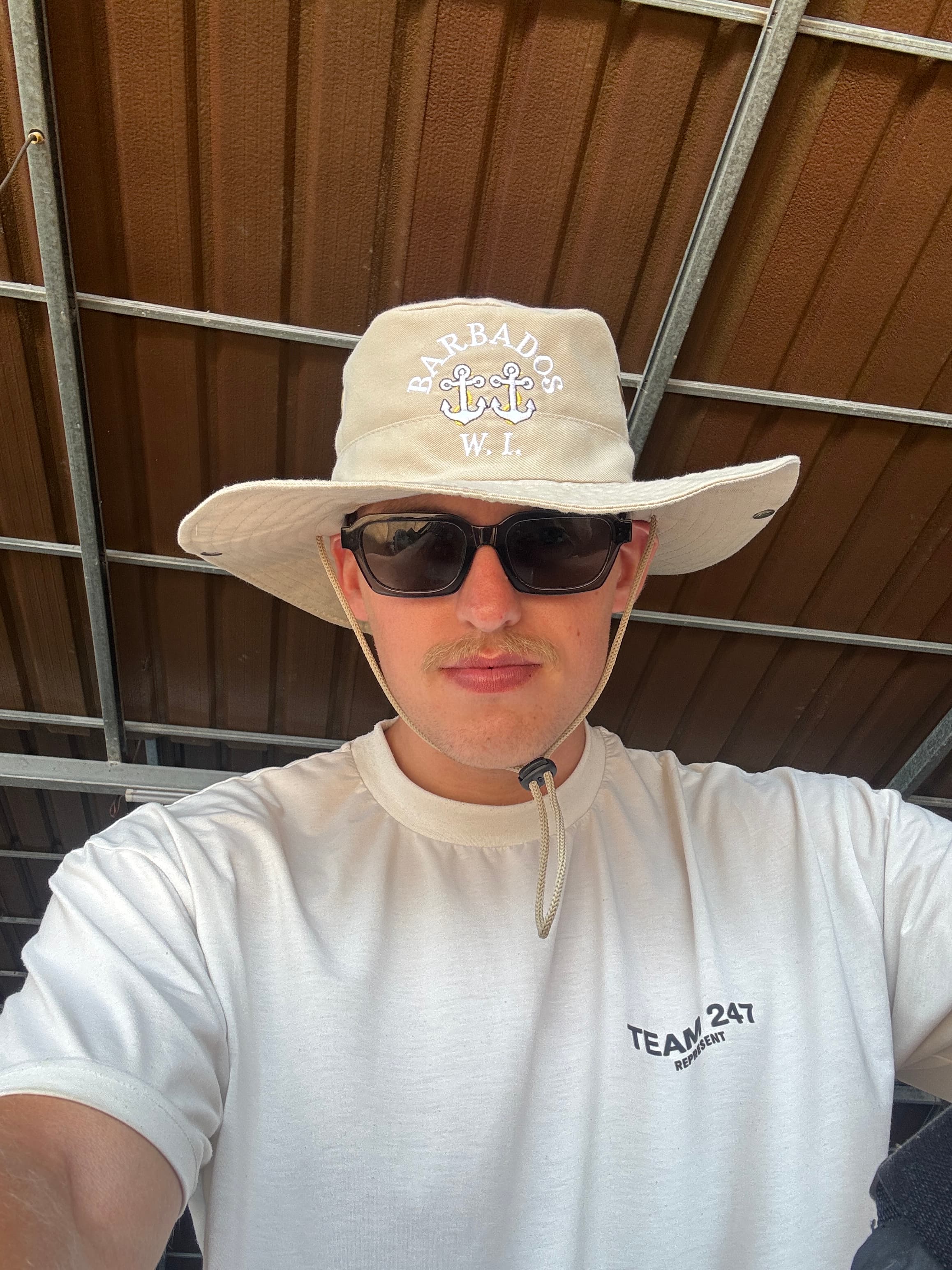 Clayton close-up wearing a Barbados hat and sunglasses